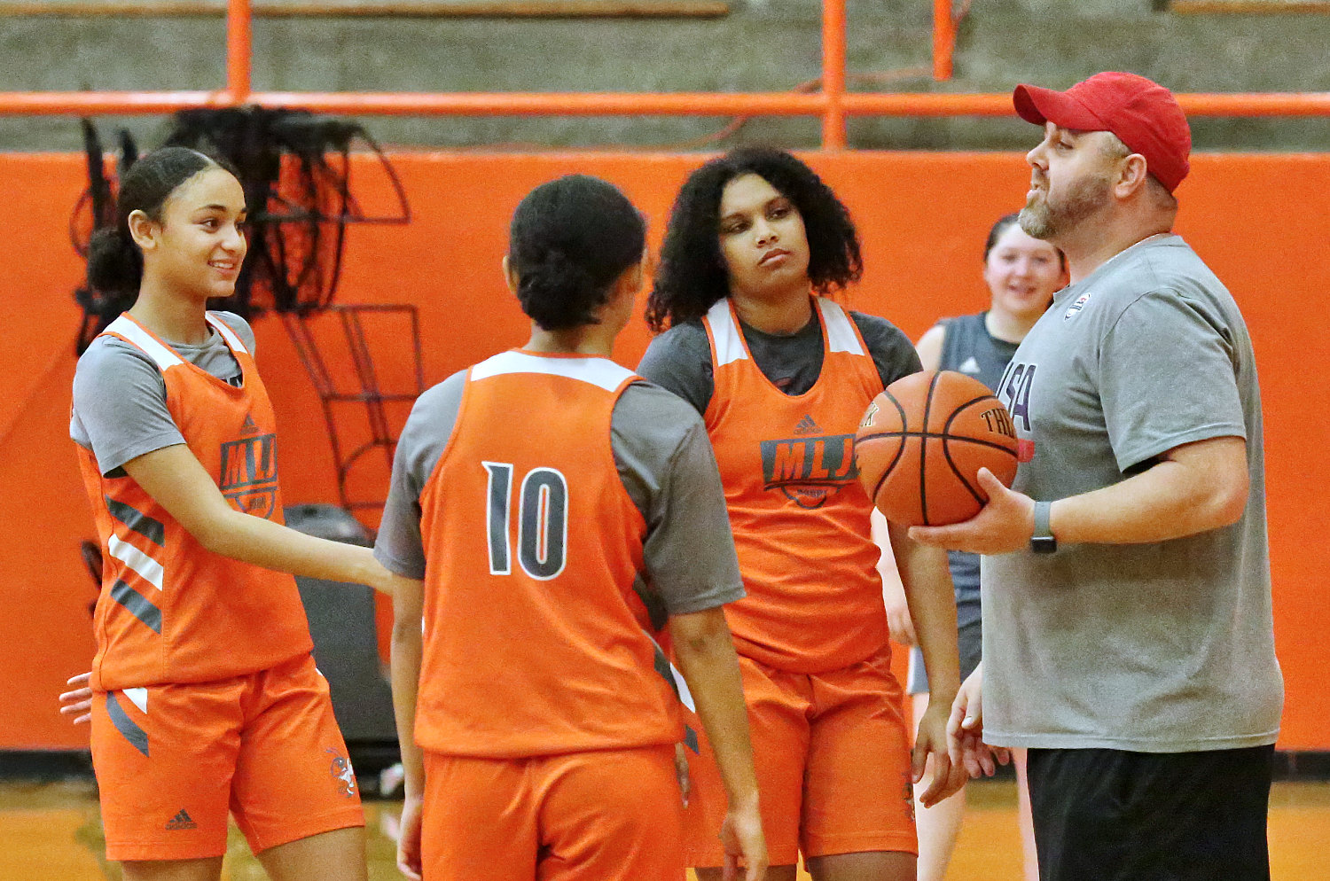 Lady Jacket head coach Alan Wilson makes a learning point at a recent practice.
